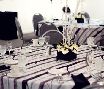 Decorated table with water, featuring a custom centerpiece