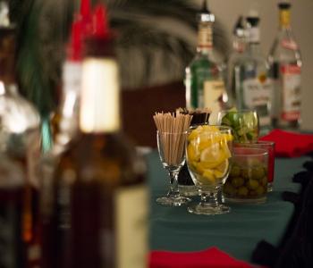 Bar table with drink garnishes in glasses