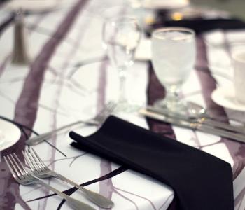 Decorated table focusing on the silverware and napkin