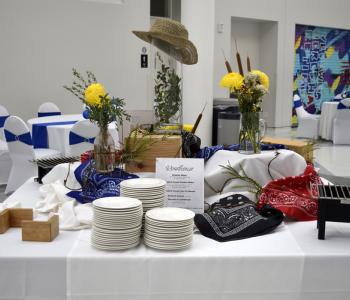 Table set up for a "Roadhouse" theme, including a cowboy hat and bandanas